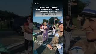 “IT’S ISRAEL FIRST EVERY DAY” Protest Stunt Shows Chained Lady Liberty