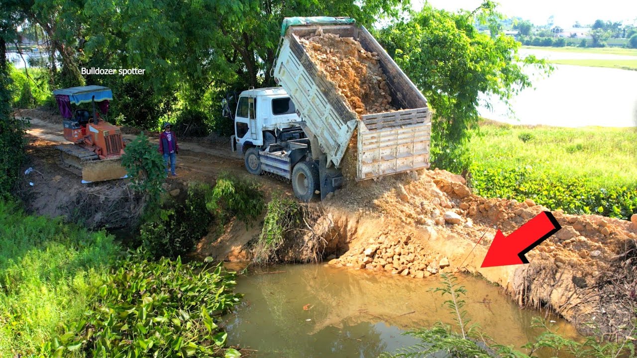 Wonderful New Activity Dump truck unloading stone repair road and Bulldozer D20P Working push fill.