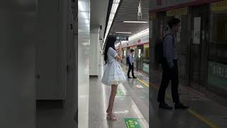 Chinese Tall Girl Wearing Costume And High Heels In Subway