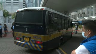 HK activist charged with secession, transported in police vehicle from court | AFP