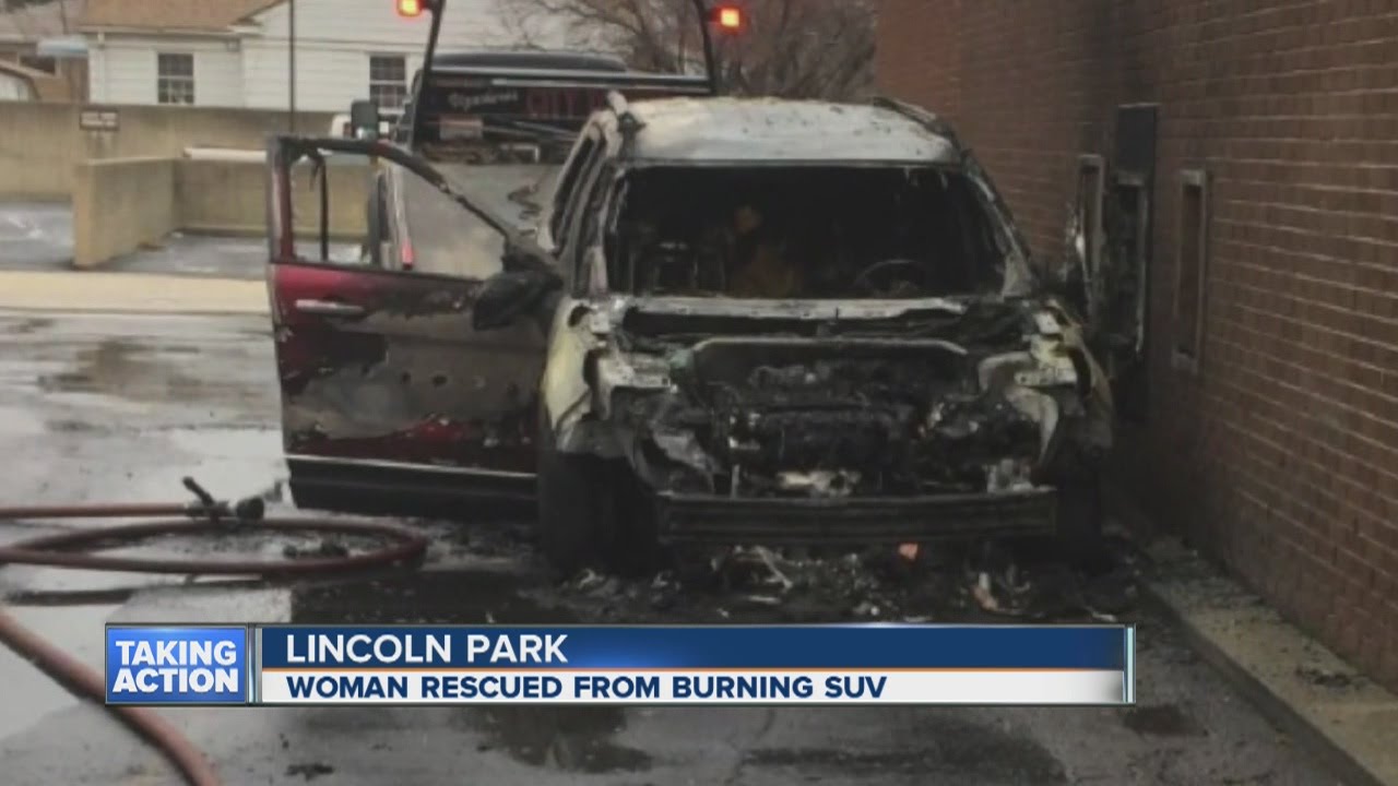 Woman rescued from burning SUV - YouTube