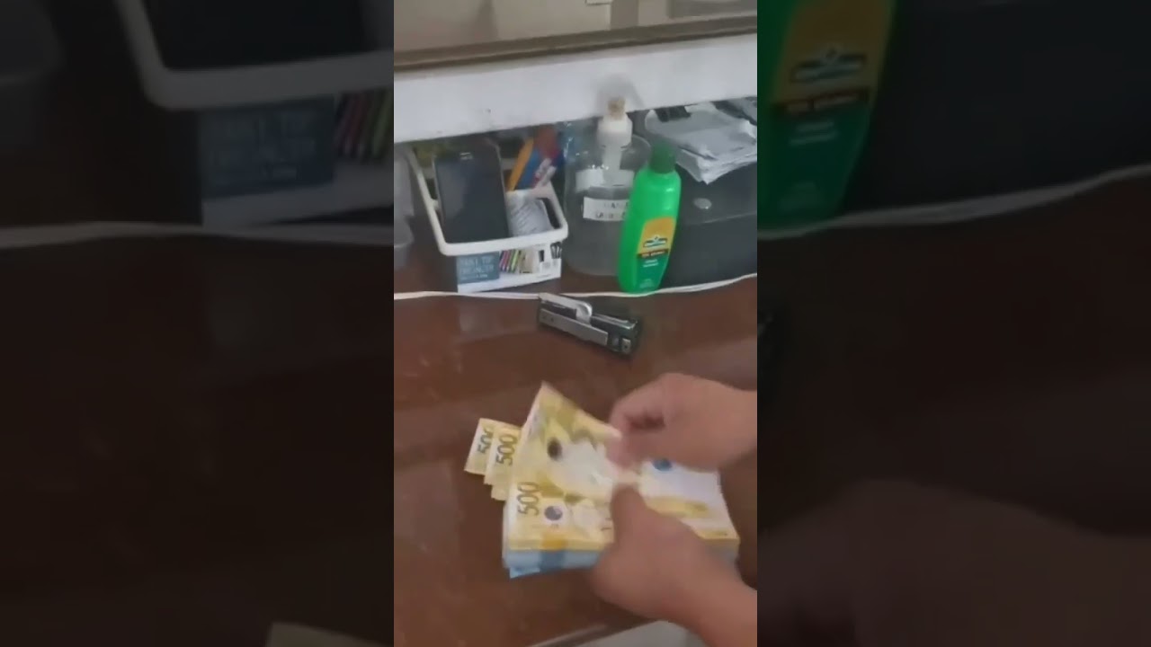 HAND COUNTING PHILIPPINE MONEY BILL.