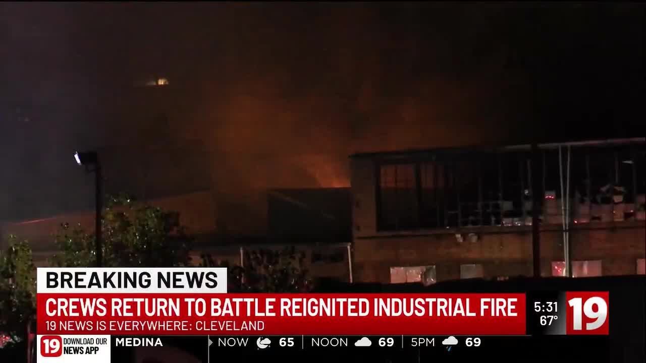 Crews return to battle reignited industrial fire - YouTube