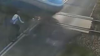 Watch as this cyclist survives a collision with a fast-moving train