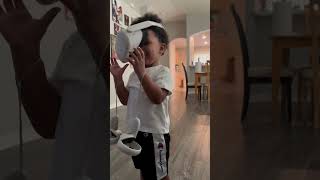Kid Playing VR Crashes Into Shelf While Laughing