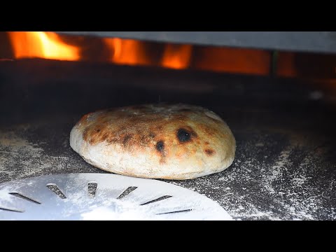 She is Making Amazing Pita Bread in A Fire Brick Oven