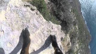 Mountain goat with gopro climbing cliffs in Mallorca