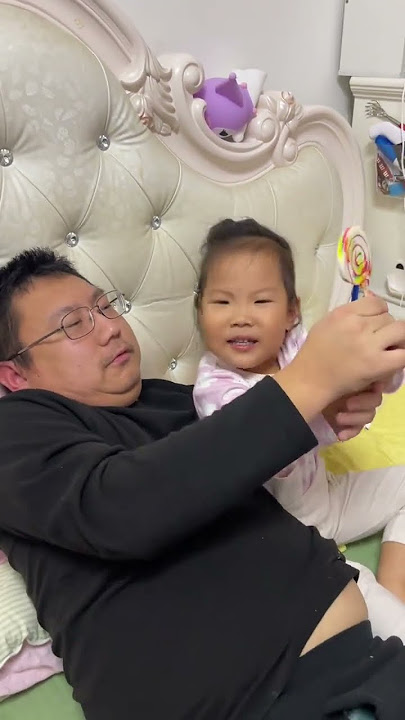 Dad bit off the lollipop to record the baby. Dad takes care of the baby. My little cute baby. Pa