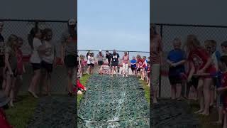 Teachers Sliding Down A Slip In Slide On Field Day