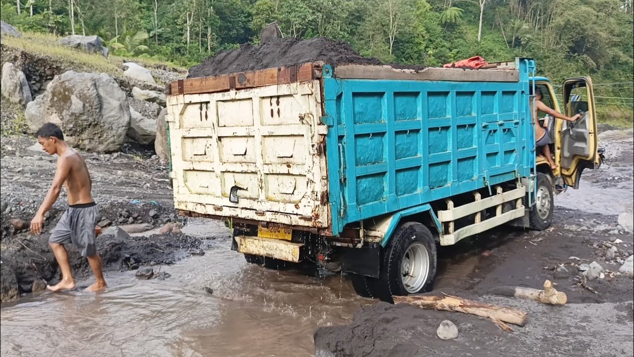 Manual Miners Load Sand Into Mitsubishi Trucks