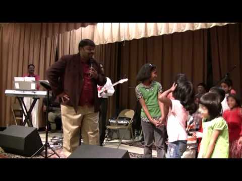 Alwin Thomas singing with kids in worship meeting ...