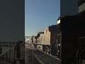 BNSF train with sadly terrible lighting passes irvine and has a slightly leaning autorack