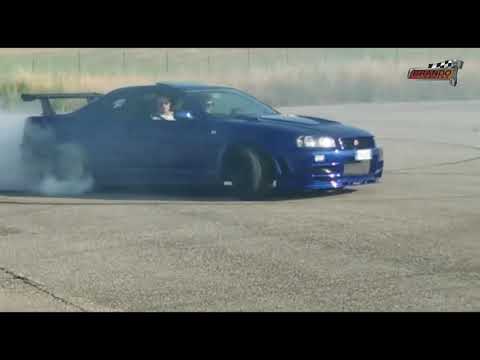 A nissan skyline gtr r34 drifting in togue on Craiyon