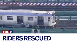 FDNY rescues riders from disabled subway train on elevated track in Queens
