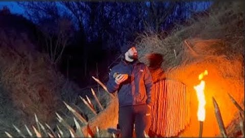 Building a warm and cozy survival shelter deep inside a large tree.Bushcraft