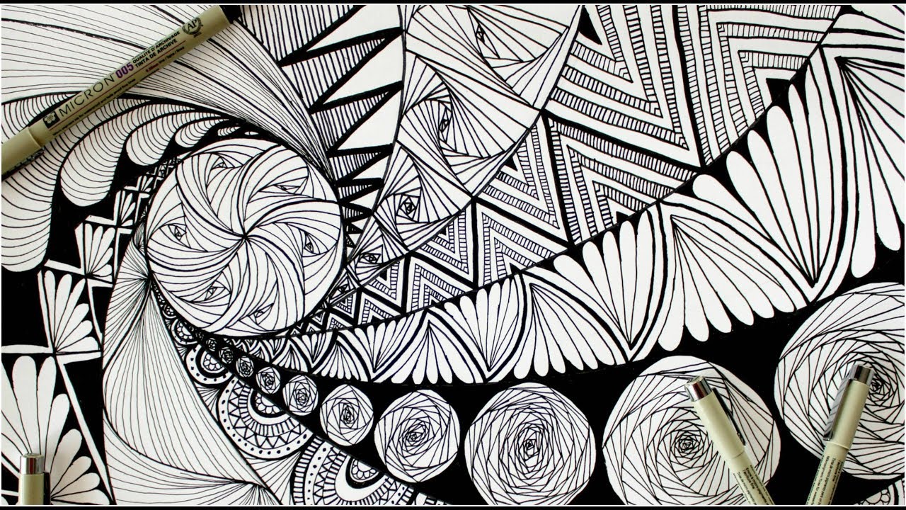 Black and white drawing of a design called Zentangle; two pens laying on artwork