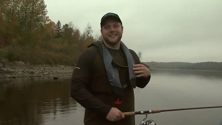 Host Rick Greene takes CFL player Jake Thomas fish...