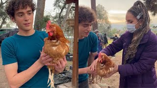 Joshua Bassett &amp; Sofia Wylie holding a chicken on the set of hsmtmts