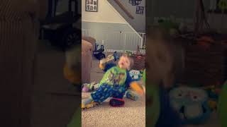 Boy accidentally slips on toy car and falls awkwardly