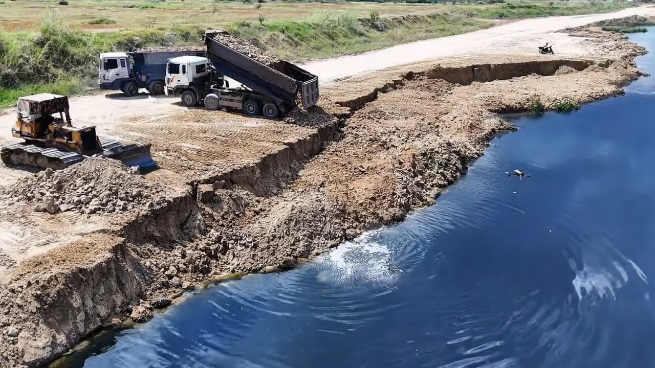 Many Dump Trucks Loading Soil Repairing Crack Sink Land With Strong Dozer