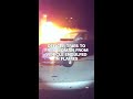 Officer tries to free woman from vehicle engulfed in flames