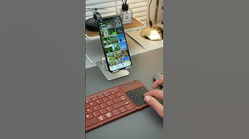 A foldable keyboard compatible with both phones and tablets, featuring Bluetooth connectivity.