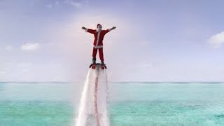 Santa Flyboarding to meet waiting kids in the Maldives
