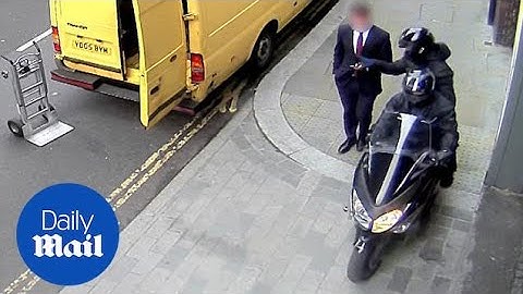 Unsuspecting pedestrian has phone snatched from hand by moped thief - Daily Mail