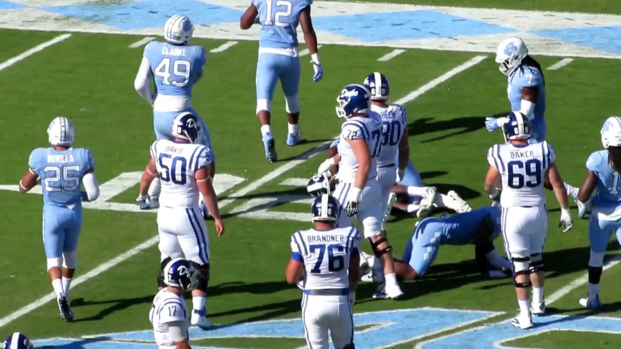 Duke's Shaun Wilson rushes, UNC's Jordon Riley tackles him