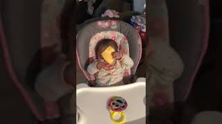 Woman throws American cheese at baby girl seated in high chair