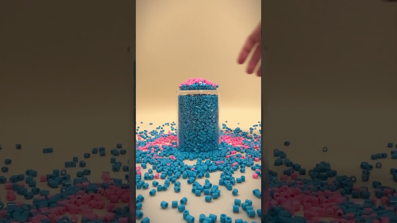 A cup within a cup and blue and pink beads  