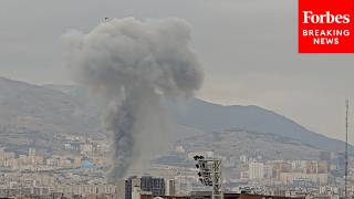 Plumes Of Smoke Rise Above Tehran Skyline After U.S. Strikes Hit Iran