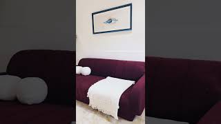 Sectional Sofa is a sculptural masterpiece sumptuously upholstered in a dreamy dark maroon bouclé.