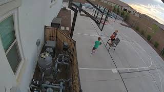 Boy uses chair to slam dunk on basketball hoop