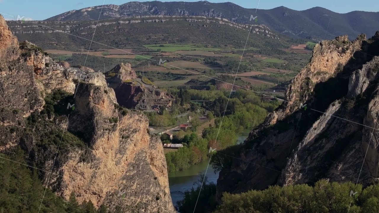 Aerial View of a River Canyon with Rock Formations and Train Tracks, Capturing the Beauty of Nature