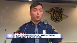 Michigan State Troopers hailed as heroes for saving woman overdosed behind moving vehicle