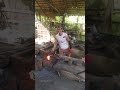 Watching a blacksmith craft a TOJOK, a traditional tool for carrying palm fruit.
