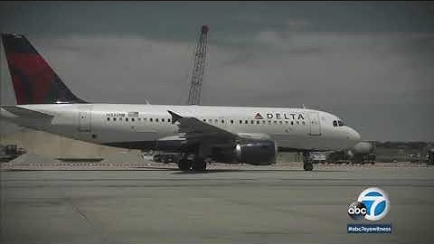 Delta flight passenger detained after opening emergency door moments before takeoff, airline says