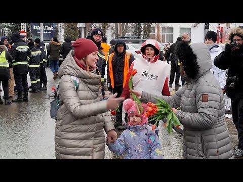 Romanians greet refugees with Women