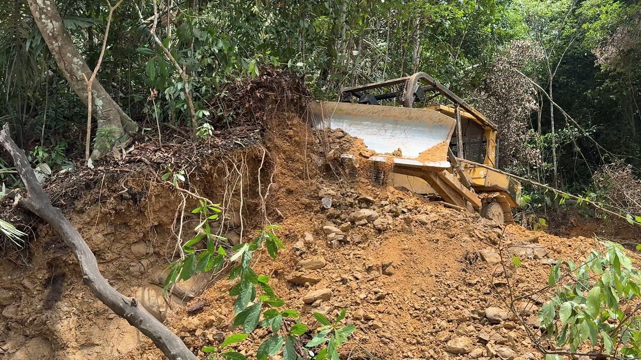 The D6R XL Bulldozer Process Cuts Through the Hill for a New Road