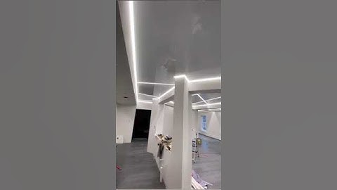 White glossy stretch ceiling with linear light