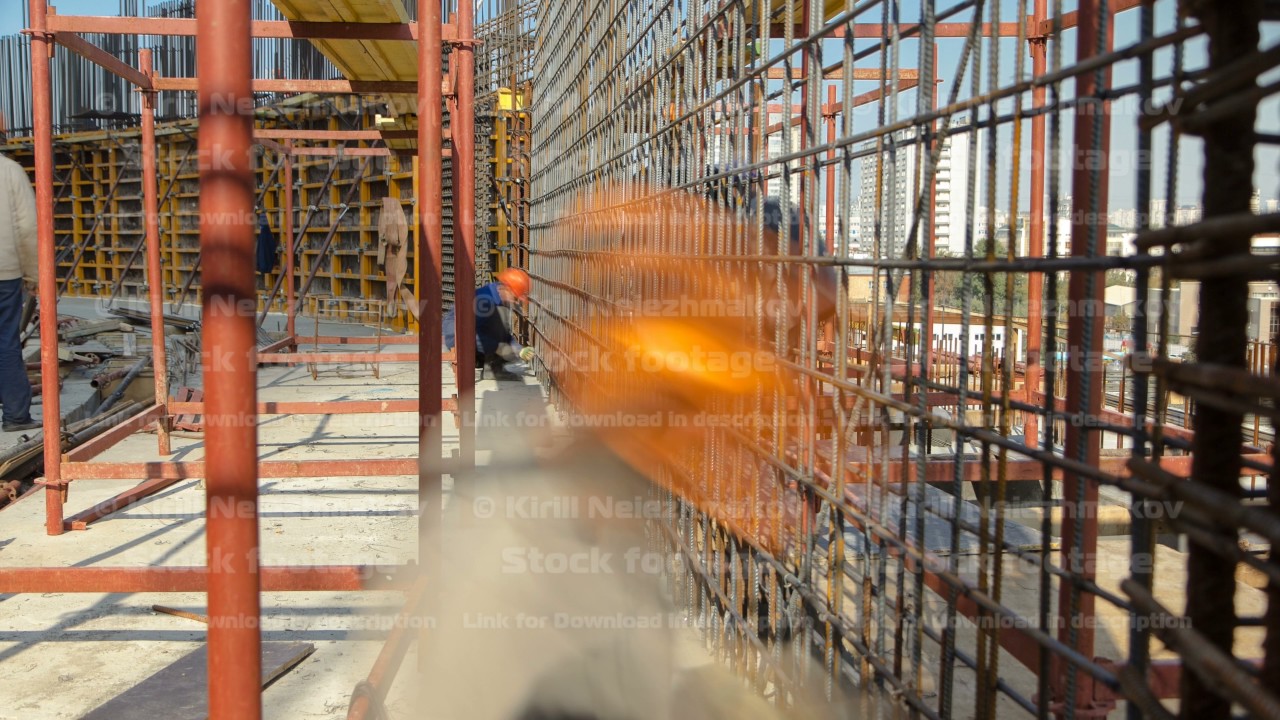 Construction workers working on steel rods used to reinforce concrete timelapse