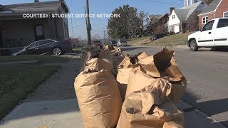 Young volunteers rake leaves, clear brush from yards to help the elderly
