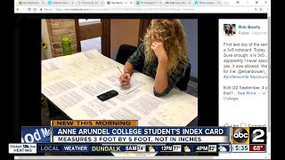 College student uses huge index card for test