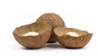 One Whole Coconut and Two Shells Halves with Flakes Rotating on White Background | Stock Footage -