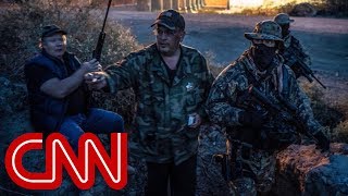 Armed militia group detains migrants at the border