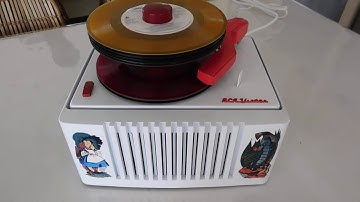 RCA Alice in Wonderland 45 RPM record player playing a stack of 45