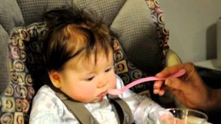 Mommy gives Ella first solid food