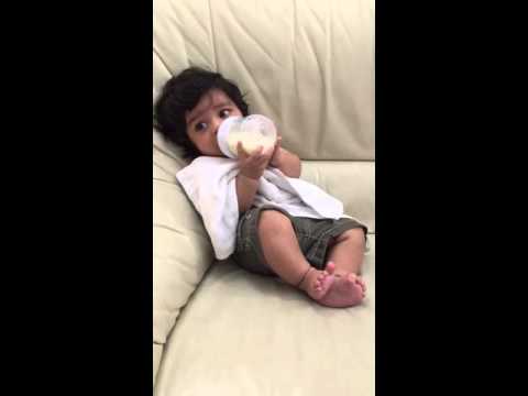3 month old baby holds his own bottle