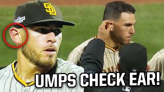 Umpires check pitcher's ears for a foreign substance, a breakdown
